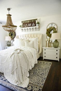 a white bed sitting in a bedroom on top of a rug