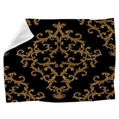 a black and gold blanket with an ornate design on it