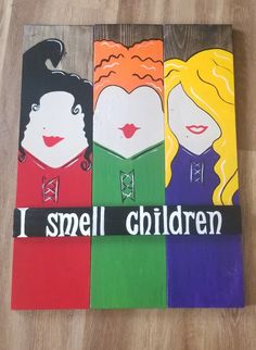 three children painted on wood with the words i smell children