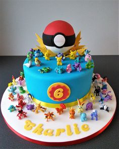 a birthday cake with pokemon figurines on it