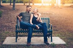 a man and woman sitting on a bench in the park