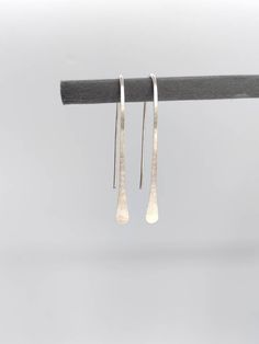 Matte satin finish, long drop recycled Sterling silver earrings,  hand-forged from a length of solid silver eco wire. The satin finish gives them a very modern look. They are made using a traditional method called planishing which flattens and smooths out the silver, before the Satin finish. This process also hardens the silver, making them tough but also lightweight and comfortable to wear. 4 or 5 cm long Silver width 0.9mm (US 19 Gauge) Each pair of earrings are handmade in the UK using tradit Modern Silver Long Drop Threader Earrings, Handmade Sterling Silver Long Drop Threader Earrings, Nickel-free Long Drop Sterling Silver Earrings, Handmade Sterling Silver Threader Earrings For Everyday, Hypoallergenic Sterling Silver Long Drop Linear Earrings, Hypoallergenic Long Drop Sterling Silver Linear Earrings, Nickel-free Long Drop Threader Earrings, Silver Linear Earrings With French Hook Gift, Handmade Minimalist Long Drop Linear Earrings