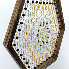 a wooden frame with beads hanging from it