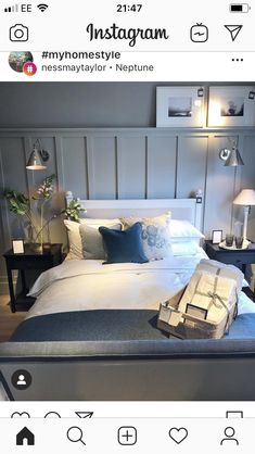 an instagram photo of a bed with pillows and blankets on it, next to two lamps