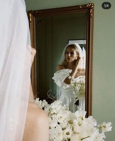 a bride looking at herself in the mirror