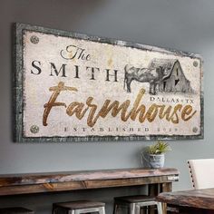 a sign that says the smith farmhouse is displayed on a wall above a table