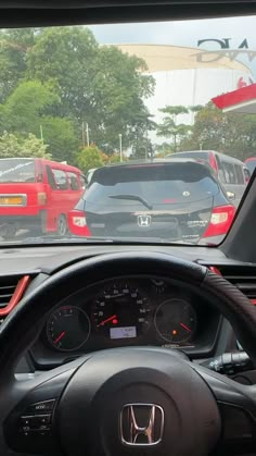 the dashboard of a car with many cars behind it