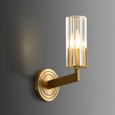 a light that is on the side of a wall with two candles in it,