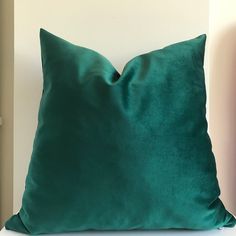 a green pillow sitting on top of a white couch