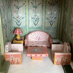 a doll house with furniture and decorations on the floor