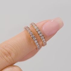 a woman's hand with two rings on her finger and one ring in the middle