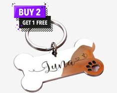 a key chain with a dog's paw on it and the words, buy 2 get 1 free