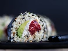 a sushi roll with fruit and rice on it