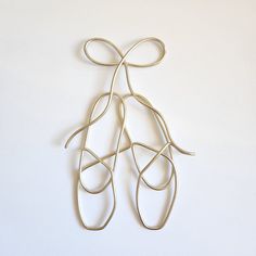 a pair of scissors are tied together on a white surface