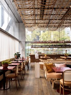 an empty restaurant with wooden tables and chairs