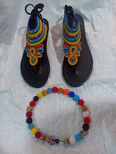 This  sandals comes with a beautiful colorful necklace This would double as a great summer accessory as well as a gift either for birthdays or Christmas. It is 100% handcrafted using colourful beads from JayAfribead A fitting guide is provided on every listing but incase of any question please reach out to me. We ship via DHL express. Thank you for visiting our shop and we hope you enjoy your purchase. Black Beaded Bohemian Sandals, Black Bohemian Beaded Sandals, Multicolor Beaded Barefoot Sandals For Vacation, Traditional Multicolor Ankle Strap Sandals, Traditional Beaded Sandals For Festivals, Bohemian Barefoot Sandals For Festival, Artisan Multicolor Sandals For Festivals, Traditional Multicolor Barefoot Sandals For Vacation, Handmade Bohemian Flat Sandals