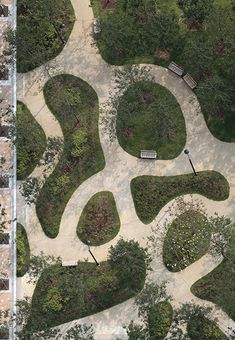 an aerial view of a park area with benches and trees in the middle of it