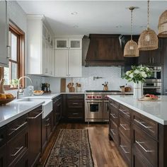 a large kitchen with wooden cabinets and white counter tops, along with an area rug on the floor