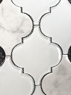 a white marble tile with black and white designs