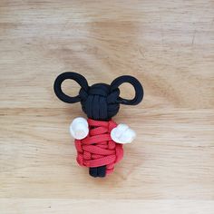 a red and black mouse made out of rope