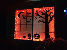 a window decorated with halloween decorations and lights