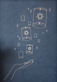 a hand holding a lite up with some drawings on it