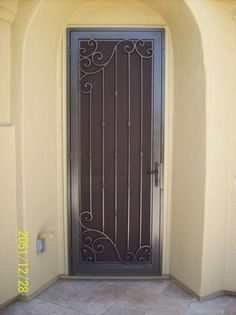 a brown door with wrought iron designs on it