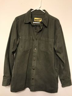 Brazos Work Force Mens Shirt Jacket Sz M Olive Green Flannel Lined Shacket. Excellent condition Snap front, smoke free 100% cotton Heavy weight canvas with flannel lining Rugged Long Sleeve Outerwear With Button Closure, Rugged Long Sleeve Outerwear With Snap Buttons, Military Cotton Shacket With Long Sleeves, Vintage Long Sleeve Flannel Shirt For Streetwear, Vintage Cotton Shacket With Long Sleeves, Vintage Cotton Shacket For Fall, Rugged Cotton Outerwear With Buttons, Rugged Long Sleeve Shacket With Pockets, Rugged Long Sleeve Top With Button Closure