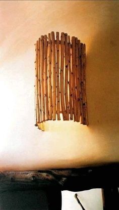 a bed with a wooden headboard made out of sticks on the wall next to it