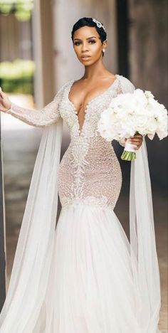 a woman in a wedding dress holding flowers