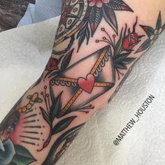 a woman's leg with tattoos on it and an hour clock in the middle