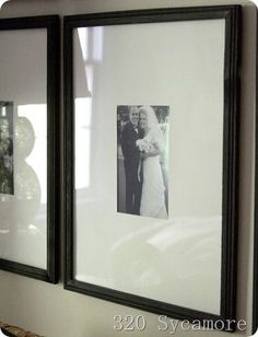 two black framed pictures hanging on the wall