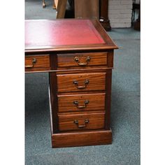 a wooden desk with three drawers on it