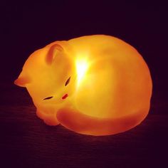 a cat shaped light sitting on top of a wooden table