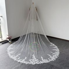 a white wedding veil hanging from the ceiling