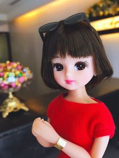 a close up of a doll with sunglasses on it's head and arms crossed