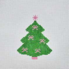 a cross - stitch christmas tree with pink bows on it's green and white background