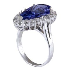 Stamped: 14K White Gold Total Ring Weight: 6.4 Grams Gemstone Weight: Total Natural Tanzanite Weight is 6.36 Carat (Measures: 17.75x9.60 mm) Color: Blue Diamond Weight: Total Natural Diamond Weight is 0.90 Carat Quantity: 21 Color: F-G, Clarity: VS2-SI1 Face Measures: 22.40x15.30 mm Sku: [702046W] Formal Blue Pear-shaped Rings, Formal Tanzanite Diamond Ring, Oval Shape, Oval Tanzanite Diamond Ring For Formal Occasions, Formal Tanzanite Diamond Ring Oval Shape, Formal Oval Tanzanite Diamond Ring, Formal Tanzanite Halo Ring, Tanzanite Brilliant Cut Formal Rings, Oval Tanzanite Ring For Formal Occasions, Formal Tanzanite Diamond Ring With Prong Setting