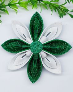 a green and white flower with leaves on it