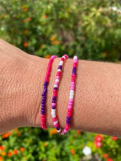 Layer up these three fun bracelets. Each is a different pattern. Colors are magenta, pink, purple and white. Made with a stretchy band for easy use. Purple Beaded Bracelets With Colorful Beads For Summer, Colorful Beaded Purple Bracelets For Summer, Purple Colorful Beaded Bracelets For Summer, Trendy Pink Beaded Wrap Bracelet, Flexible Pink Beaded Bracelets, Flexible Pink Beaded Bracelet, Purple Friendship Bracelets For Summer, Pink Hypoallergenic Beaded Bracelets For Beach, Hypoallergenic Pink Beaded Bracelets For Beach