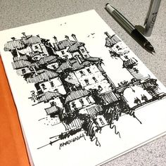 a pen is laying on top of a piece of paper that has been drawn with ink