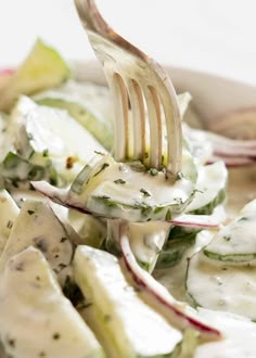 a fork with some food on it in a bowl