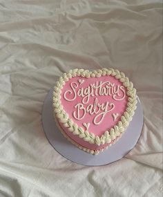 a heart shaped birthday cake with the words sagithan's baby written on it