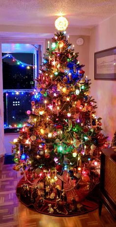 a brightly lit christmas tree in a living room