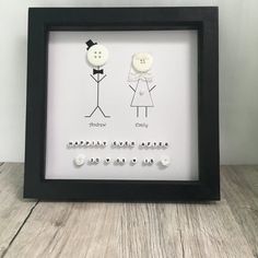 a black frame with two white buttons in it and the words happy father's day written below