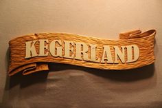 a wooden sign that says kegerland on it's side hanging from the wall