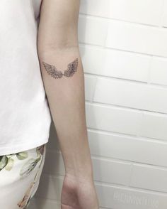 a woman with a small tattoo on her arm