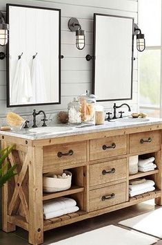 a bathroom with two sinks and mirrors on the wall