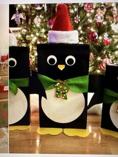 three penguins are standing next to each other in front of a christmas tree and decorated with presents