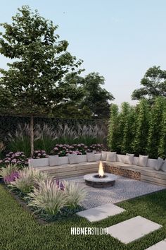 an outdoor fire pit surrounded by grass and flowers